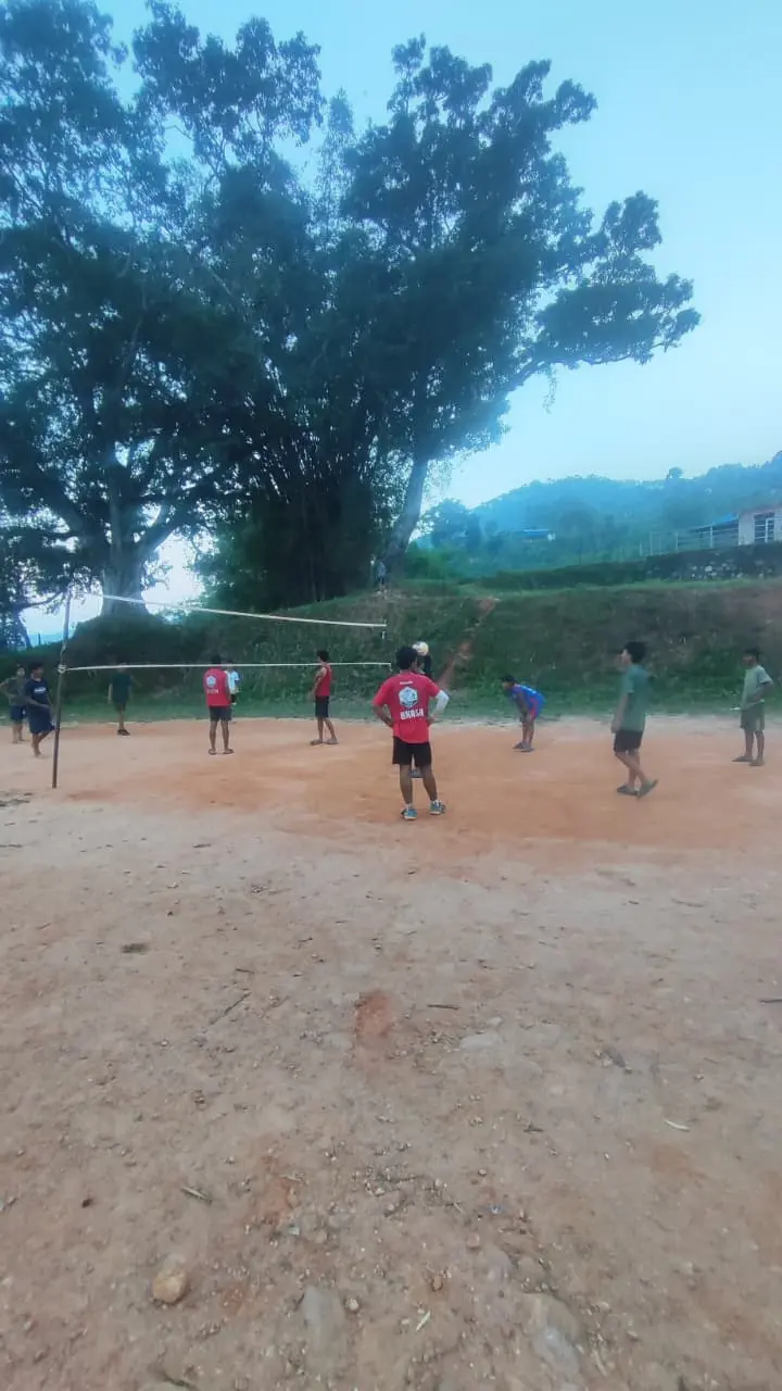 Leerlingen in Nepal spelen samen volleybal op het schoolplein.